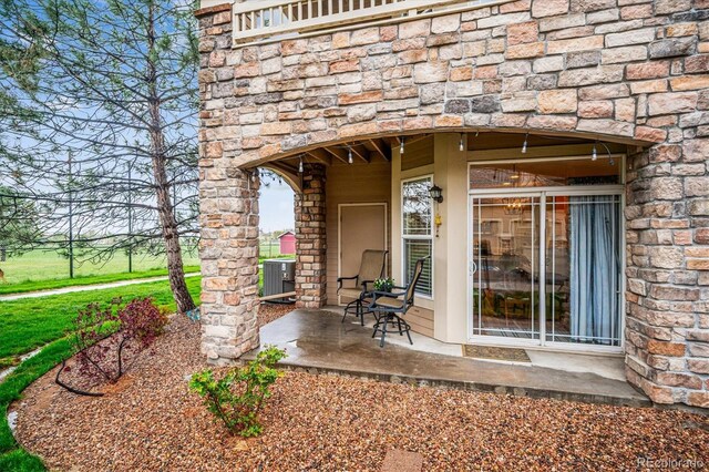 8520 S Holland Ln Unit 102, Littleton, CO 80128 - property entrance with central AC unit and stone siding
