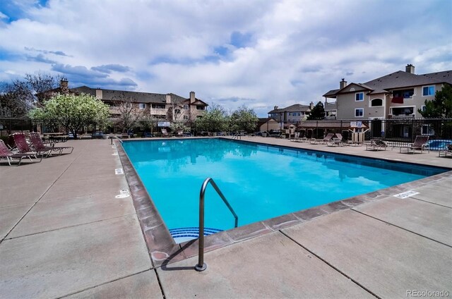 8520 S Holland Ln Unit 102, Littleton, CO 80128 - community pool with fence, a patio area, and a residential view