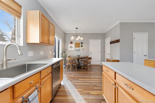 kitchen with ornamental molding, dishwasher, sink, and hanging light fixtures