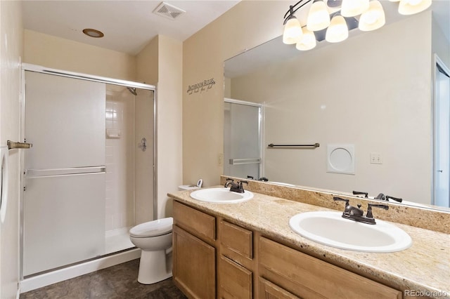 bathroom featuring toilet, an enclosed shower, and vanity