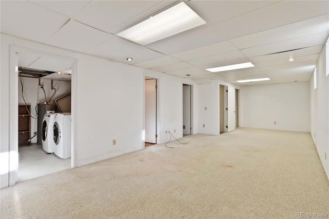 basement with washer and clothes dryer, carpet, and a drop ceiling