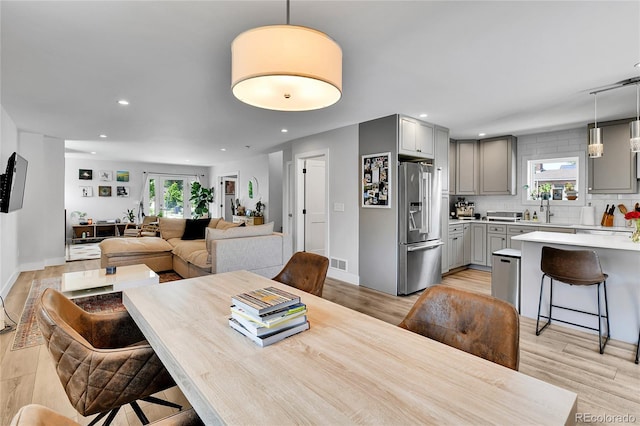 3178 N Race St, Denver, CO 80205 - dining area featuring light wood-style floors, recessed lighting, and baseboards