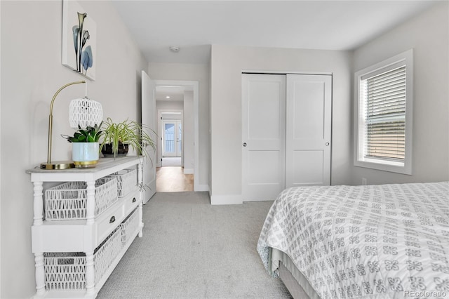 3178 N Race St, Denver, CO 80205 - bedroom with light colored carpet, a closet, and baseboards