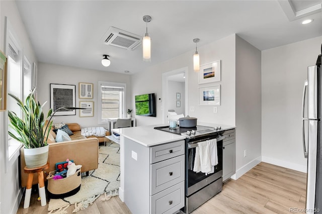 3178 N Race St, Denver, CO 80205 - kitchen with stainless steel appliances, light wood-type flooring, open floor plan, a peninsula, and light countertops