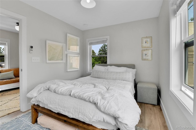 3178 N Race St, Denver, CO 80205 - bedroom featuring multiple windows, light wood finished floors, and baseboards