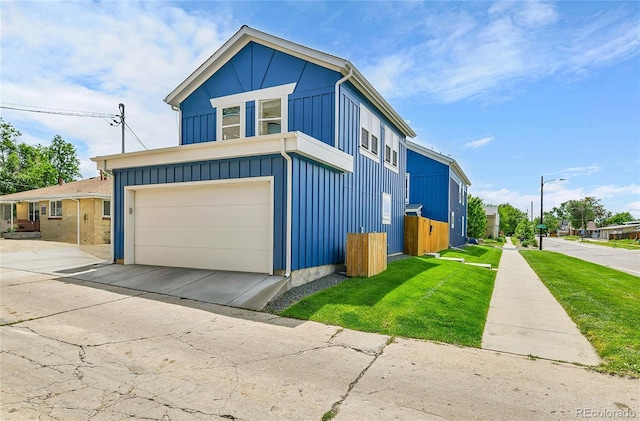 3178 N Race St, Denver, CO 80205 - view of front of property with board and batten siding, concrete driveway, a front lawn, and a garage