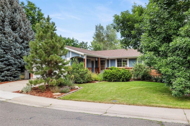 8369 W 77th Way, Arvada, CO 80005 - view of front facade with a front lawn, concrete driveway, covered porch, and a garage