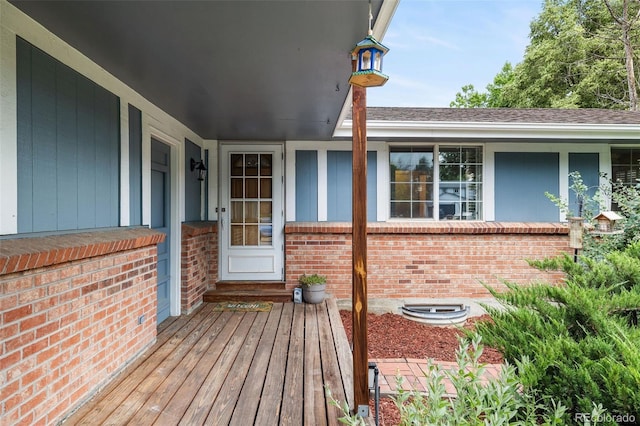 8369 W 77th Way, Arvada, CO 80005 - doorway to property featuring brick siding and a porch