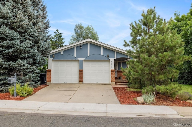 8369 W 77th Way, Arvada, CO 80005 - view of front of home with brick siding, a garage, and driveway