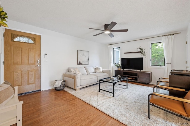 8369 W 77th Way, Arvada, CO 80005 - living room with a ceiling fan, wood finished floors, and a textured ceiling