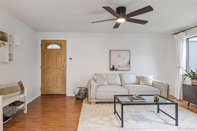 8369 W 77th Way, Arvada, CO 80005 - living room with wood finished floors, a ceiling fan, and a textured ceiling