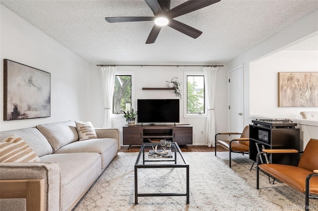 8369 W 77th Way, Arvada, CO 80005 - living room with wood finished floors, ceiling fan, and a textured ceiling