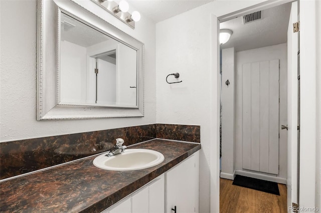 8369 W 77th Way, Arvada, CO 80005 - bathroom featuring vanity and wood finished floors