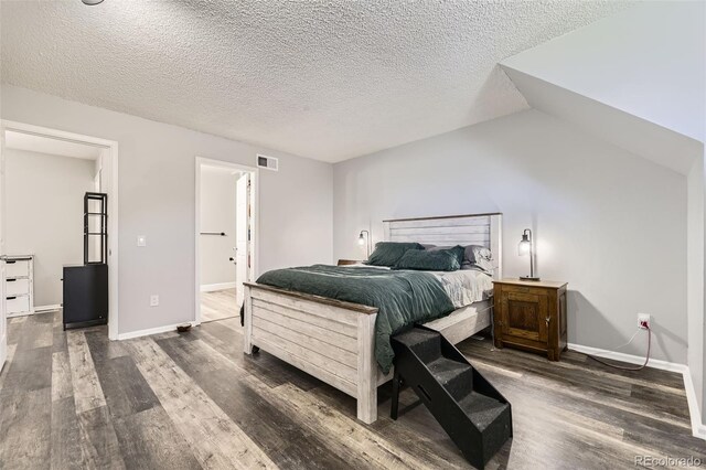 10685 W Apishapa Pass, Littleton, CO 80127 - bedroom featuring dark wood-type flooring, a textured ceiling, and baseboards
