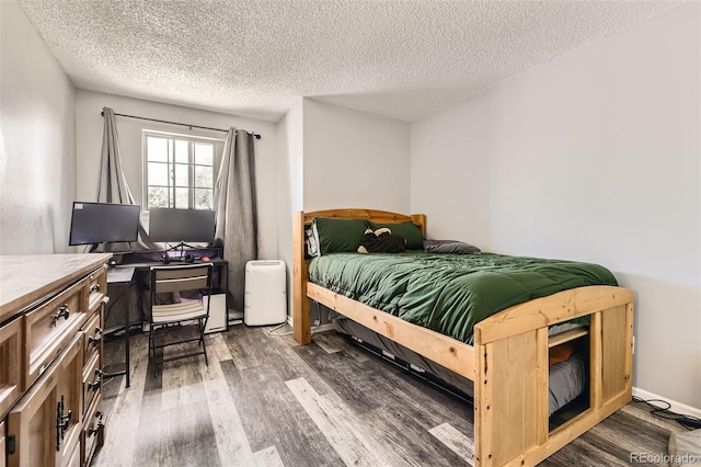 10685 W Apishapa Pass, Littleton, CO 80127 - bedroom with wood finished floors, a textured ceiling, and a desk