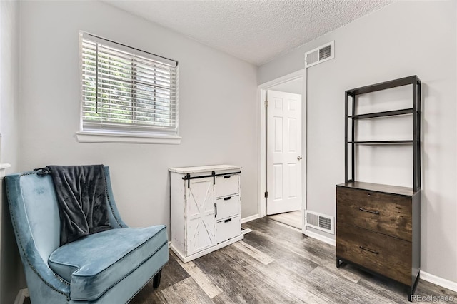 10685 W Apishapa Pass, Littleton, CO 80127 - sitting room with wood finished floors, a textured ceiling, and baseboards