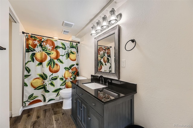 10685 W Apishapa Pass, Littleton, CO 80127 - bathroom with wood finished floors, vanity, toilet, and a shower with curtain