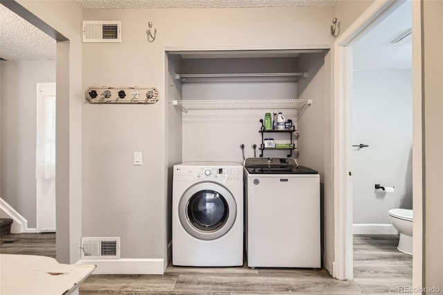 10685 W Apishapa Pass, Littleton, CO 80127 - washroom with washer and dryer, wood finished floors, and baseboards