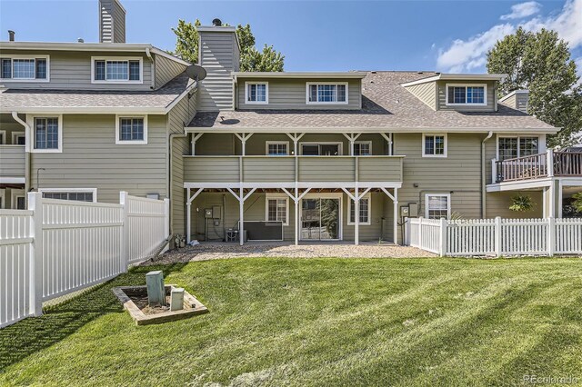 10685 W Apishapa Pass, Littleton, CO 80127 - rear view of house featuring a chimney, a shingled roof, a patio area, and a balcony