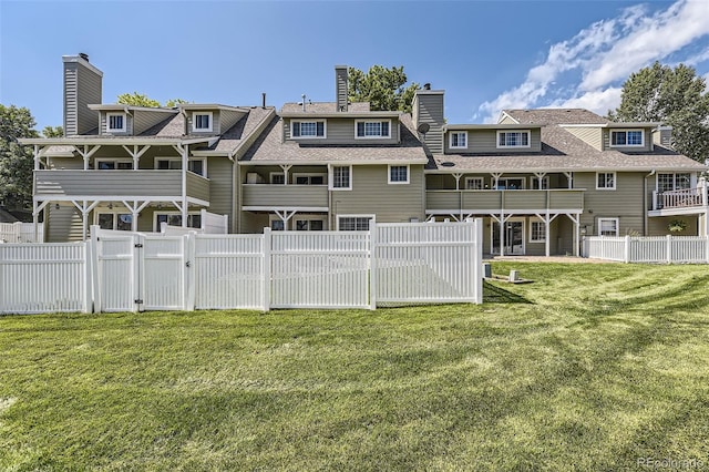 10685 W Apishapa Pass, Littleton, CO 80127 - back of property with a gate, a chimney, and a shingled roof