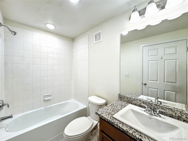 3865 Presidio Pt Unit 101, Colorado Springs, CO 80920 - bathroom featuring toilet, vanity, bathtub / shower combination, and a textured wall