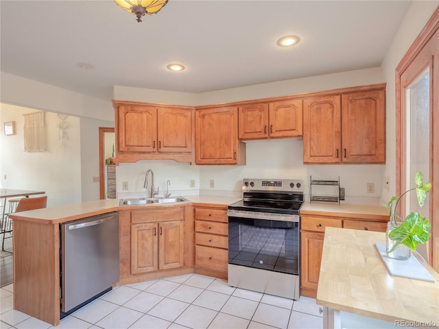 120 S San Juan Ave, Buena Vista, CO 81211 - kitchen with appliances with stainless steel finishes, a sink, light countertops, a peninsula, and recessed lighting