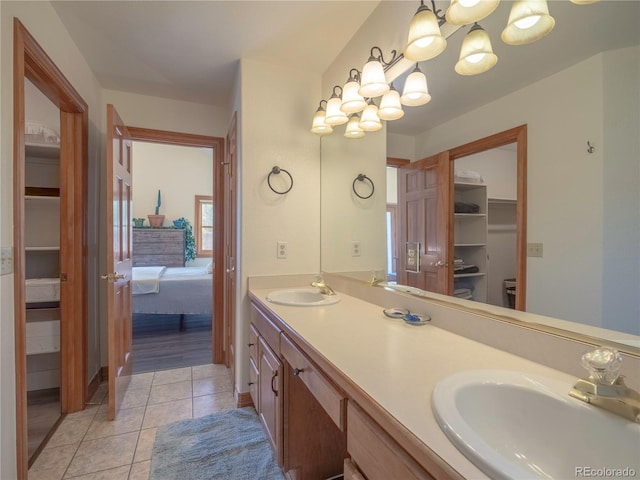 120 S San Juan Ave, Buena Vista, CO 81211 - ensuite bathroom featuring a chandelier, tile patterned flooring, double vanity, and a walk in closet
