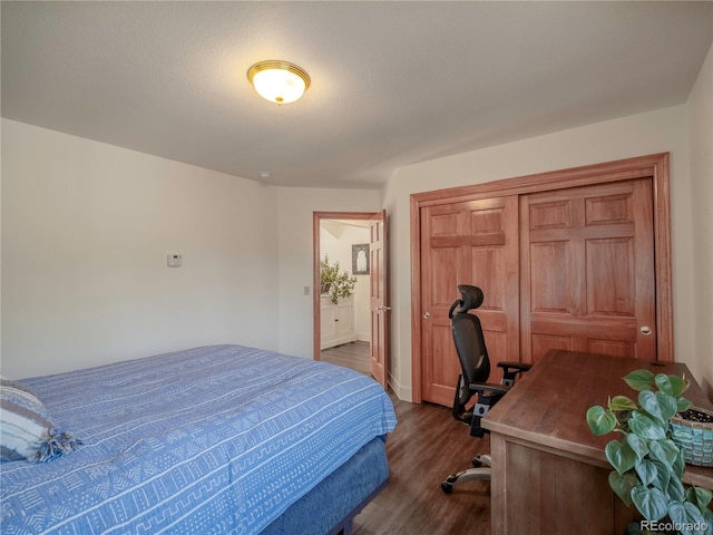 120 S San Juan Ave, Buena Vista, CO 81211 - bedroom with dark wood-type flooring, an office area, a closet, and baseboards