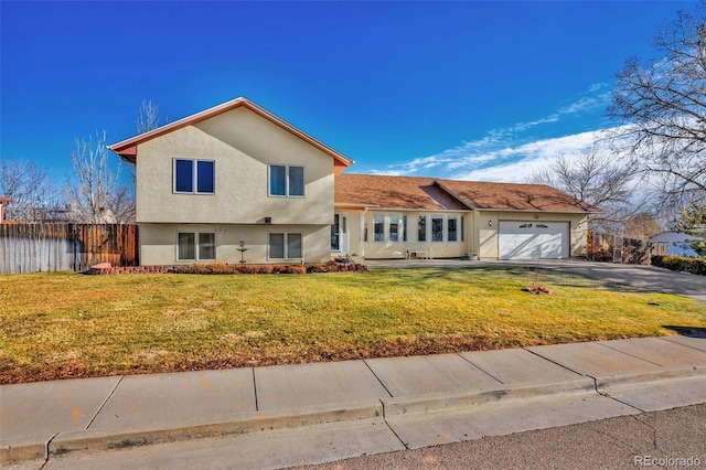 view of front of house with a front yard and a garage