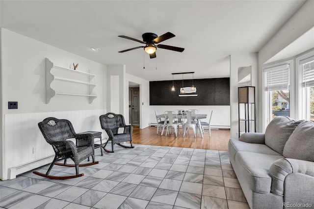 living room with ceiling fan and light wood-type flooring