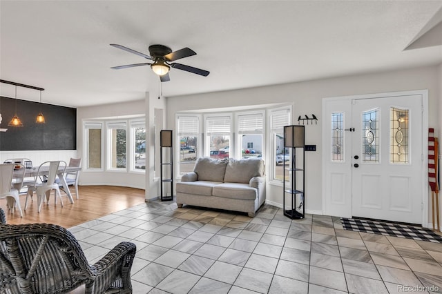 living room featuring light tile patterned floors and ceiling fan