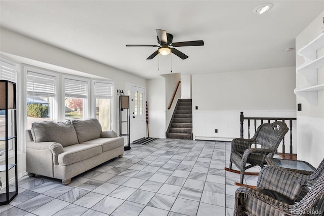 living room with ceiling fan and a baseboard radiator