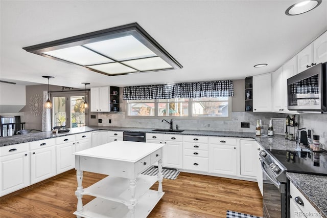 kitchen with hanging light fixtures, sink, appliances with stainless steel finishes, dark hardwood / wood-style flooring, and white cabinetry