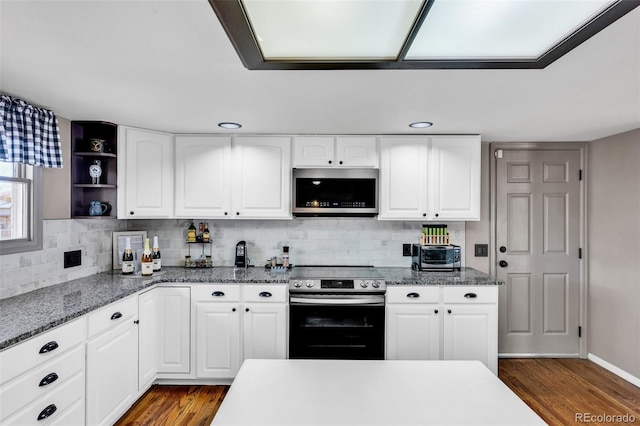 kitchen with white cabinets, dark hardwood / wood-style flooring, and stainless steel appliances