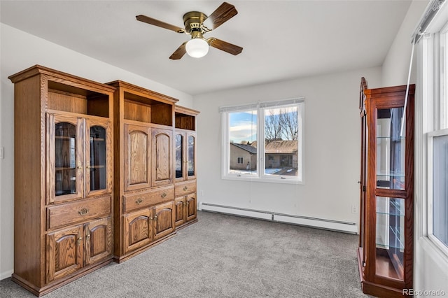 bedroom featuring baseboard heating, ceiling fan, and light colored carpet