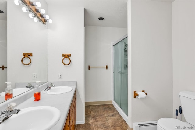 bathroom featuring vanity, toilet, a shower with shower door, and a baseboard radiator