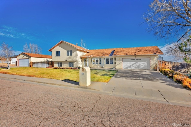 view of front of house with a garage and a front lawn