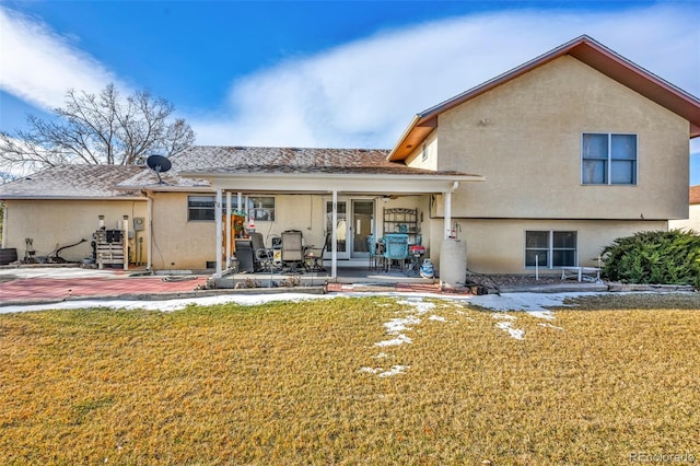 back of house with a patio, central AC, water heater, and a lawn