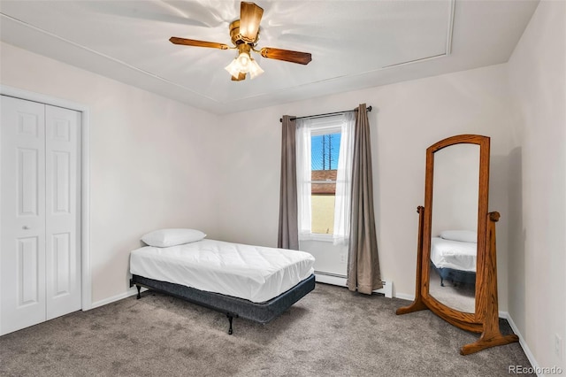 carpeted bedroom with ceiling fan, a closet, and a baseboard radiator