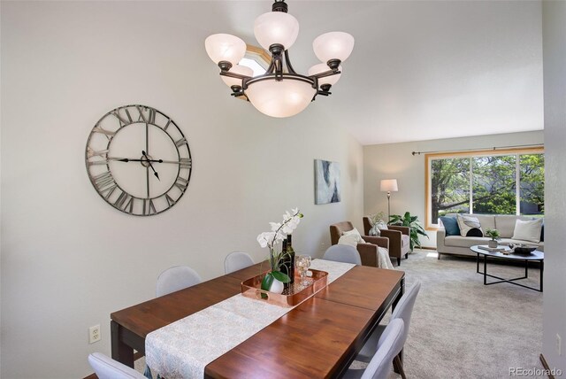 7877 W 110th Dr, Westminster, CO 80021 - dining area featuring a chandelier, vaulted ceiling, and carpet flooring