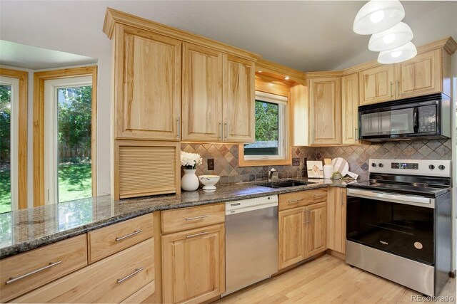 7877 W 110th Dr, Westminster, CO 80021 - kitchen featuring appliances with stainless steel finishes, light brown cabinets, and plenty of natural light