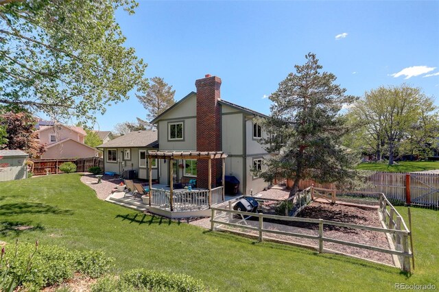 7877 W 110th Dr, Westminster, CO 80021 - back of house featuring a chimney, a patio area, and a vegetable garden