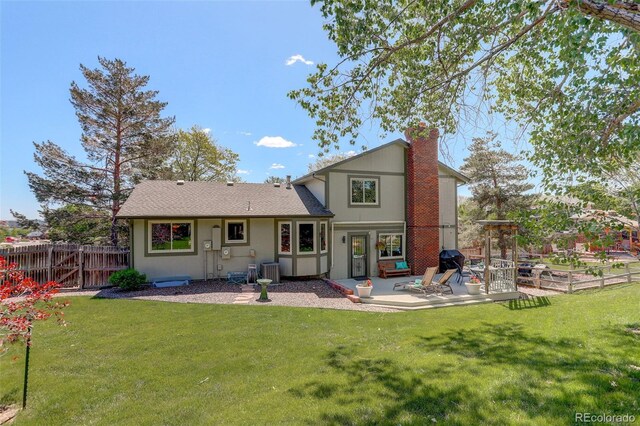 7877 W 110th Dr, Westminster, CO 80021 - rear view of house with a patio, a chimney, and cooling unit