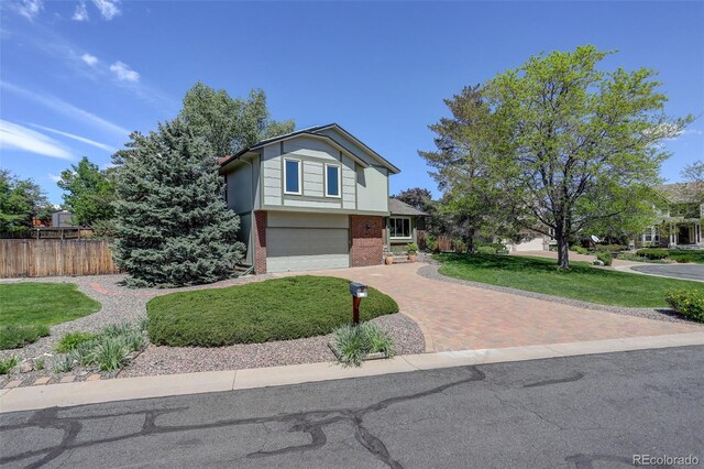 7877 W 110th Dr, Westminster, CO 80021 - view of front of house with decorative driveway, brick siding, and a garage