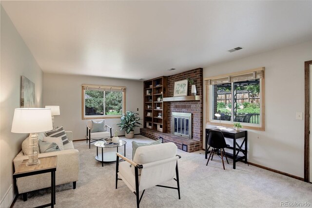 7877 W 110th Dr, Westminster, CO 80021 - living area with baseboards, a fireplace, and light colored carpet