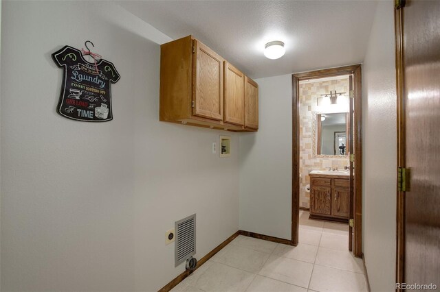 7877 W 110th Dr, Westminster, CO 80021 - laundry area featuring electric dryer hookup, hookup for a washing machine, cabinet space, baseboards, and light tile patterned flooring