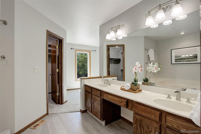 7877 W 110th Dr, Westminster, CO 80021 - full bath featuring wood finished floors, double vanity, and baseboards