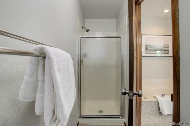 7877 W 110th Dr, Westminster, CO 80021 - bathroom featuring a shower stall and a textured wall