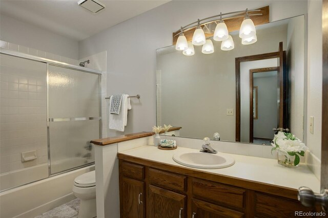 7877 W 110th Dr, Westminster, CO 80021 - bathroom with toilet, vanity, and bath / shower combo with glass door