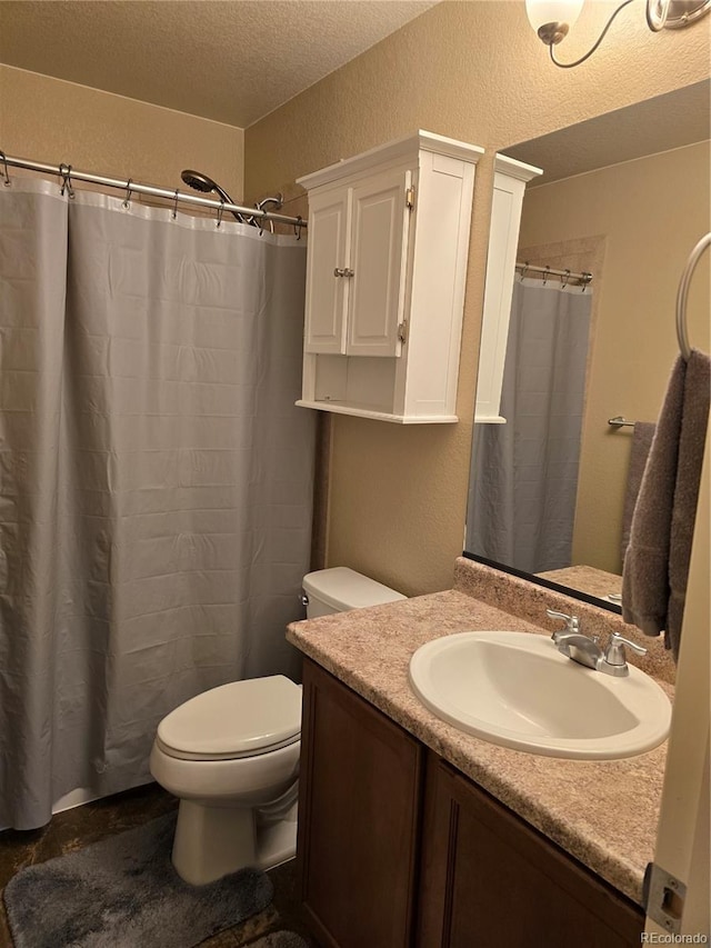 5131 Delphinium Cir, Brighton, CO 80601 - bathroom with a textured wall, toilet, vanity, a textured ceiling, and a shower with shower curtain